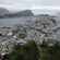 Two hilly islands covered with buildings sit in a bay under an overcast sky